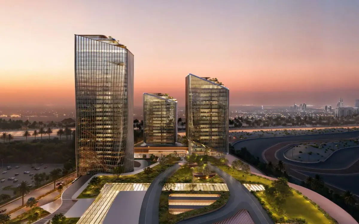 O1NE District — commercial towers at sunset beside the Dubai Autodrome